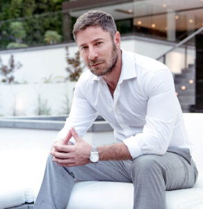 top realtor aaron kirman posing for photo