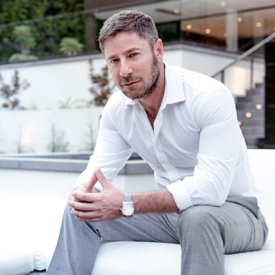 top realtor aaron kirman posing for photo