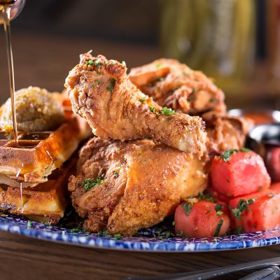 Yardbird’s signature chicken served with watermelon and waffles