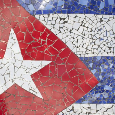 A vibrant mosaic artwork depicting the Cuban flag, with a red triangle featuring a white star, alongside blue and white stripes, symbolizing the nation's spirit and artistry within the post.
